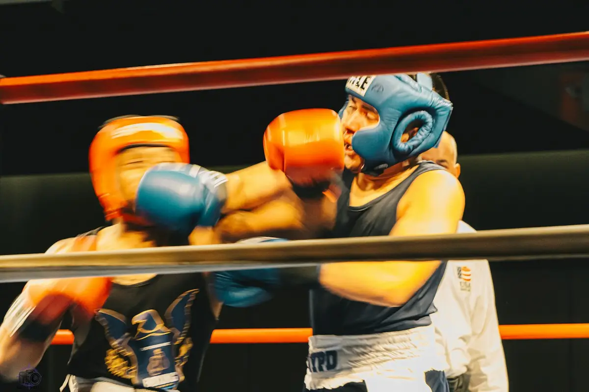 Two novice boxers in head guards trading punches